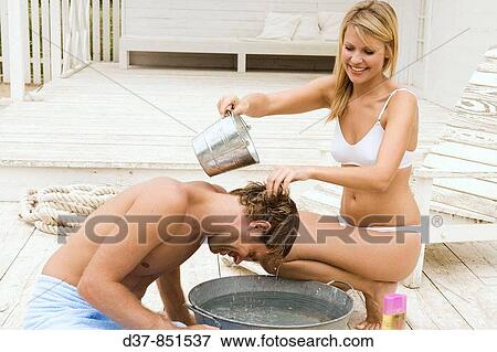 Couple having fun at home washing hair View Large Photo Image Stock Photo - Couple having fun at home washing hair. Fotosearch