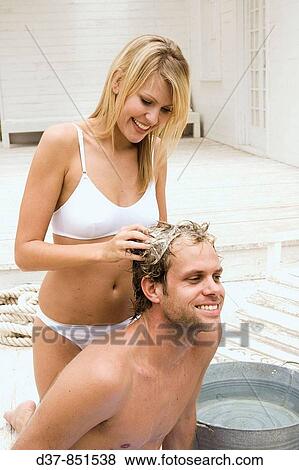 Couple having fun at home washing hair View Large Photo Image Stock Photo - Couple having fun at home washing hair. Fotosearch