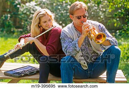 Stock Photography - couple having fun, playing music. Fotosearch