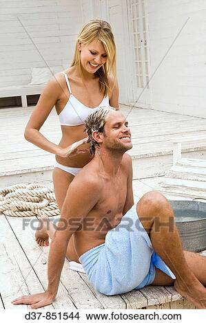 Picture - Couple having fun washing hair. Fotosearch