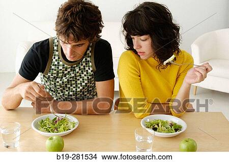 Couple having meal at home View Large Photo Image Picture - Couple having meal at home. Fotosearch