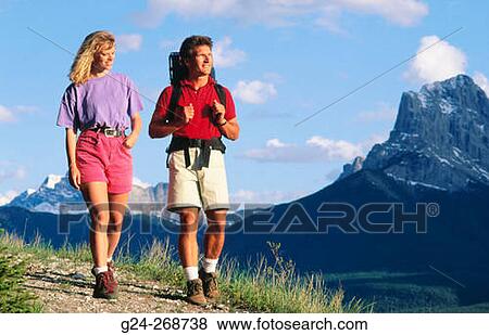Stock Photo - Couple hiking on trail. Banff National Park. Canada. Fotosearch