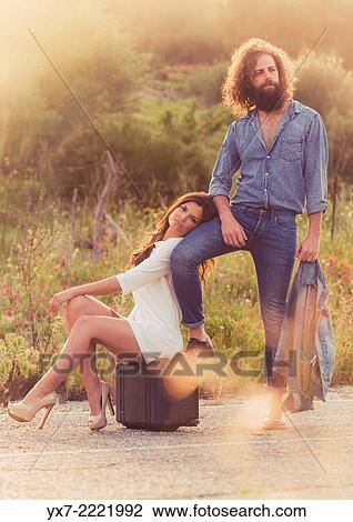 Couple hitch hiking on the side of the road. Tarifa, Cadiz, Andalusia, Spain, Europe. View Large Photo Image Stock Image - Couple hitch hiking on the side of the road. Tarifa, Cadiz, Andalusia, Spain, Europe.. Fotosearch