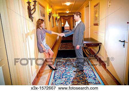 Couple holding hands in a hotel corridor View Large Photo Image Stock Photo - Couple holding hands in a hotel corridor. Fotosearch
