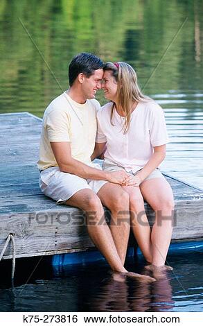 Couple holding hands on a dock View Large Photo Image Stock Photograph - Couple holding hands on a dock. Fotosearch