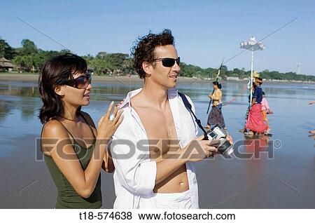 couple holidaying and taking snapshot on beach View Large Photo Image Stock Photo - couple holidaying and taking snapshot on beach. Fotosearch