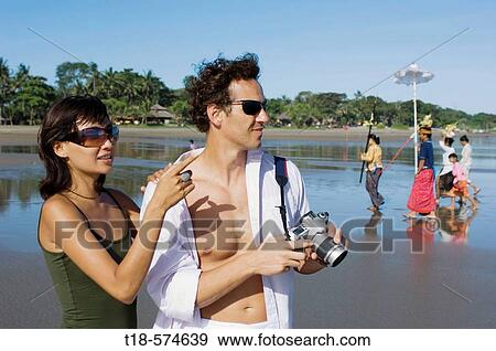 couple holidaying and taking snapshot on beach View Large Photo Image Stock Photo - couple holidaying and taking snapshot on beach. Fotosearch