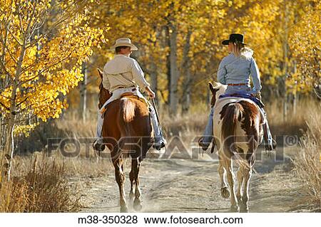 Stock Photo - Couple horseback riding near Sun Valley, Idaho. USA. Fotosearch