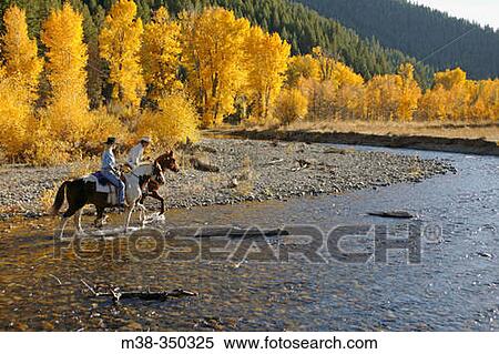 Couple horseback riding near Sun Valley, Idaho. USA View Large Photo Image Stock Photography - Couple horseback riding near Sun Valley, Idaho. USA. Fotosearch