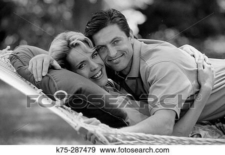 Couple hugging in hammock View Large Photo Image Stock Photo - Couple hugging in hammock. Fotosearch