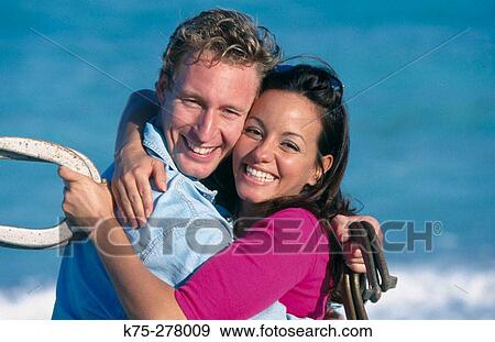 couple hugging in the middle of a horseshoe game View Large Photo Image Stock Photo - couple hugging in the middle of a horseshoe game. Fotosearch