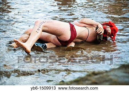 Couple hugging in the mud at the Przystanek Woodstock - Europe's largest open air festival in Kostrzyn, Poland View Large Photo Image Stock Image - Couple hugging in the mud at the Przystanek Woodstock - Europe's largest open air festival in Kostrzyn, Poland. Fotosearch