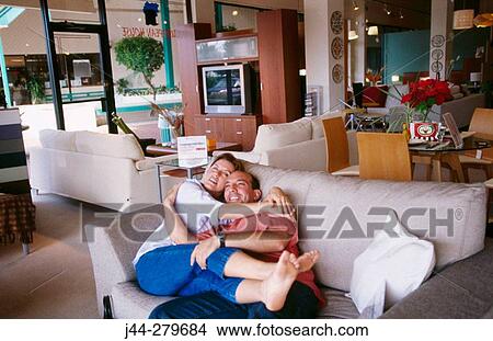 Couple hugging on a sofa in a furniture store View Large Photo Image Picture - Couple hugging on a sofa in a furniture store. Fotosearch