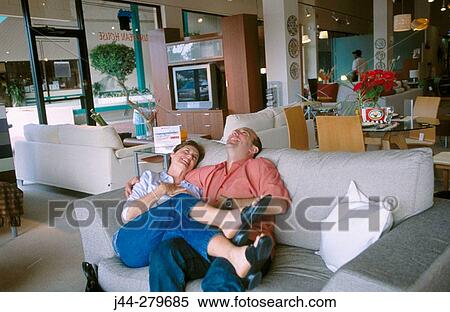 Couple hugging on a sofa in a furniture store View Large Photo Image Stock Photography - Couple hugging on a sofa in a furniture store. Fotosearch