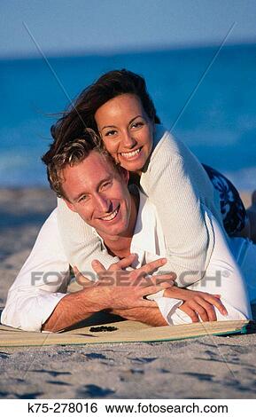 Stock Photograph - couple hugging on the beach. Fotosearch