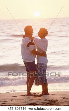 couple hugging on the beach View Large Photo Image Stock Photograph - couple hugging on the beach. Fotosearch