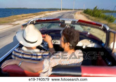 Stock Photo - Couple in 1950 Chevrolet convertible, Cuba. Fotosearch