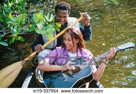 Picture - couple in a canoe. Fotosearch