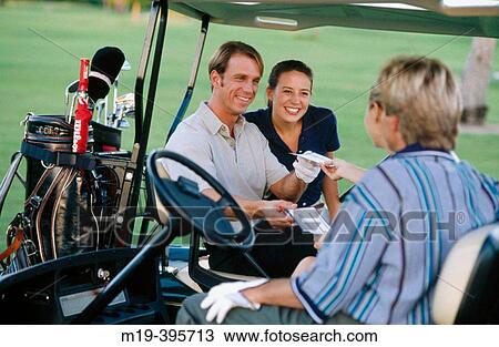 Stock Image - couple in a golf cart. Fotosearch