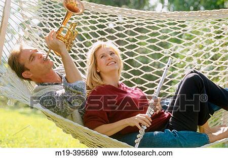 couple in a hammock, playing music View Large Photo Image Stock Photo - couple in a hammock, playing music. Fotosearch