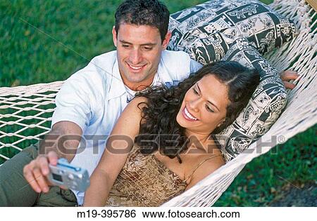 Stock Photograph - couple in a hammock with camera. Fotosearch