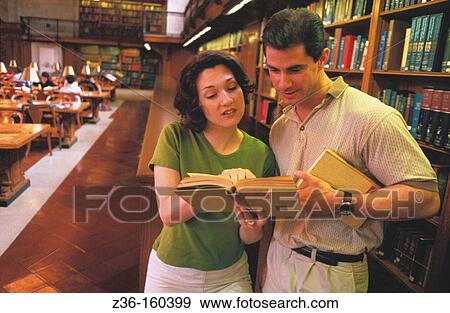 Stock Photo - Couple in a library. Fotosearch