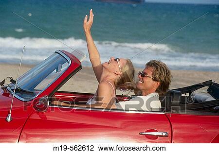 Stock Image - couple in a red covertible. Fotosearch