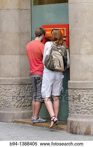 Couple in an ATM. Barcelona. Catalonia. Spain. View Large Photo Image Stock Photography - Couple in an ATM. Barcelona. Catalonia. Spain.. Fotosearch