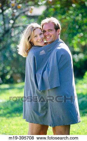 couple in an oversized shirt View Large Photo Image Stock Photo - couple in an oversized shirt. Fotosearch