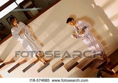 couple in bathrobe standing on stairs holding cups View Large Photo Image Stock Photography - couple in bathrobe standing on stairs holding cups. Fotosearch