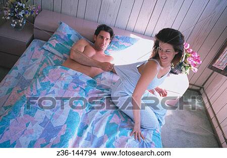 Couple in bed View Large Photo Image Picture - Couple in bed. Fotosearch