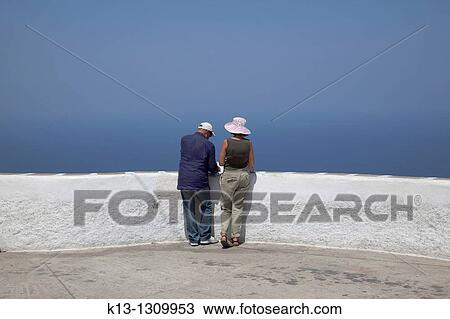 Couple in Castro of Island of Folegandros, Cyclades, Greece View Large Photo Image Stock Image - Couple in Castro of Island of Folegandros, Cyclades, Greece. Fotosearch