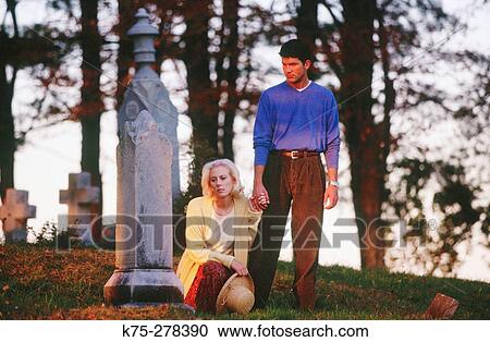Stock Image - Couple in cemetery. Fotosearch