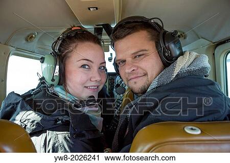 Stock Image - Couple in Cessna flying over Northern Iceland.. Fotosearch