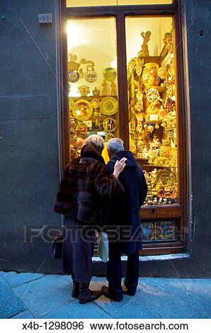 Couple in front of shop in the old town of Siena, Tuscany, Central Italy. View Large Photo Image Stock Photograph - Couple in front of shop in the old town of Siena, Tuscany, Central Italy.. Fotosearch