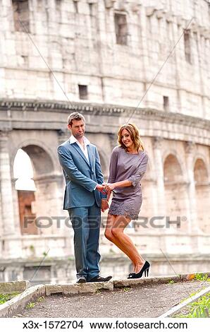 Couple in front of the Roman Colosseum View Large Photo Image Picture - Couple in front of the Roman Colosseum. Fotosearch