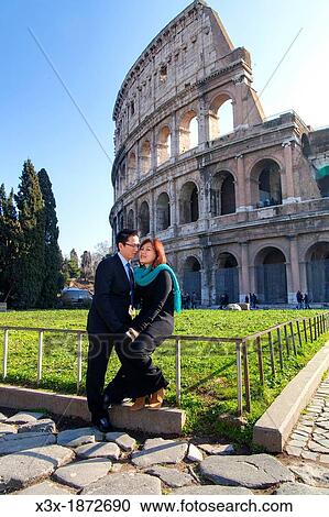 Couple in front of the Roman Colosseum Rome Italy View Large Photo Image Stock Image - Couple in front of the Roman Colosseum Rome Italy. Fotosearch