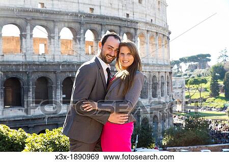 Couple in front of the roman Colosseum in Rome Italy View Large Photo Image Stock Photo - Couple in front of the roman Colosseum in Rome Italy. Fotosearch