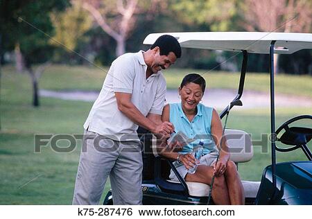 couple in golf cart View Large Photo Image Stock Photograph - couple in golf cart. Fotosearch