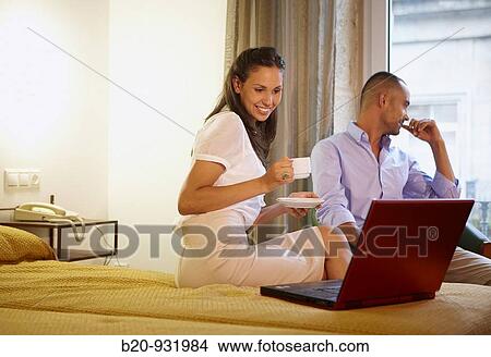 Picture - Couple in hotel room. Fotosearch