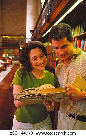 Couple in library View Large Photo Image Stock Photo - Couple in library. Fotosearch