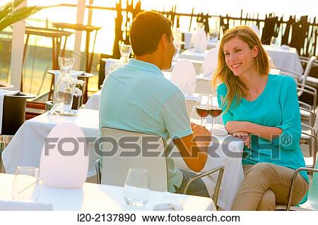 Stock Image - Couple in outdoor restaurant. Fotosearch