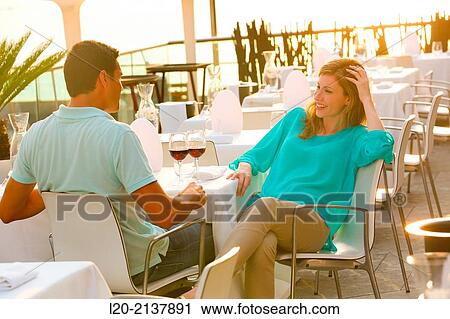 Couple in outdoor restaurant View Large Photo Image Stock Image - Couple in outdoor restaurant. Fotosearch