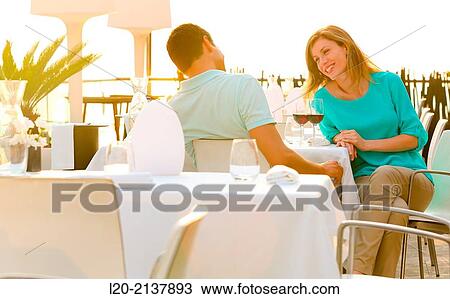 Stock Image - Couple in outdoor restaurant. Fotosearch