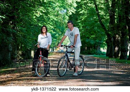Stock Image - Couple in Park with Bicycles, Estonia. Fotosearch