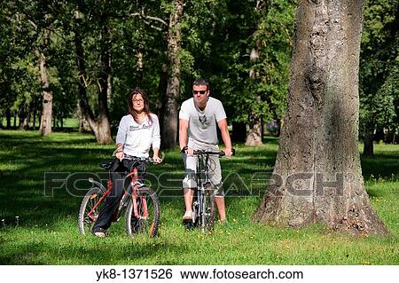 Couple in Park with Bicycles, Estonia View Large Photo Image Stock Photograph - Couple in Park with Bicycles, Estonia. Fotosearch