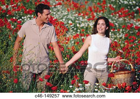 Couple in poppy field View Large Photo Image Stock Photo - Couple in poppy field. Fotosearch