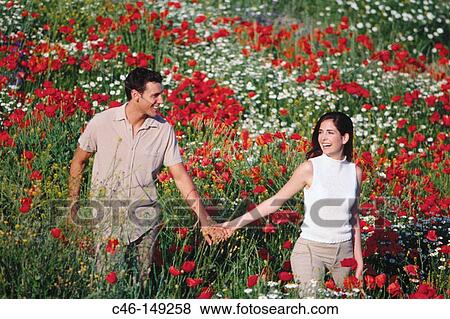 Couple in poppy field View Large Photo Image Stock Photo - Couple in poppy field. Fotosearch