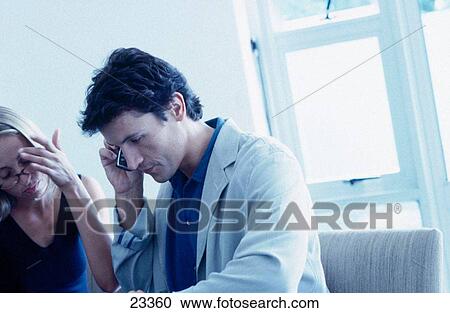 Couple in restaurant, man on cell phone View Large Photo Image Stock Image - Couple in restaurant, man on cell phone. Fotosearch