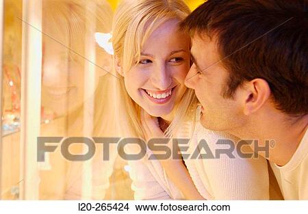 Couple in shopping center, looking at jewelry View Large Photo Image Picture - Couple in shopping center, looking at jewelry. Fotosearch